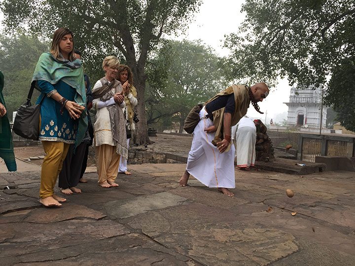 Breaking the coconut before entering the temple. Shattering the outer hard shell which is symbolic of the ego to reveal the pure white flesh inside which is symbolic of our soul which is no different than God.