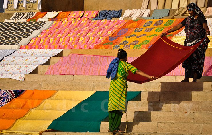 Indian women drying clothes on a river bank, Varanasi, India