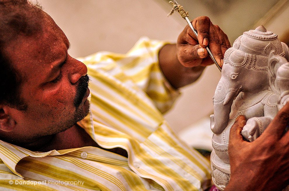 A sculptor expertly carves the final touches on to this Ganesha statue in the seaside fishing village of Mamallapuram, South India.